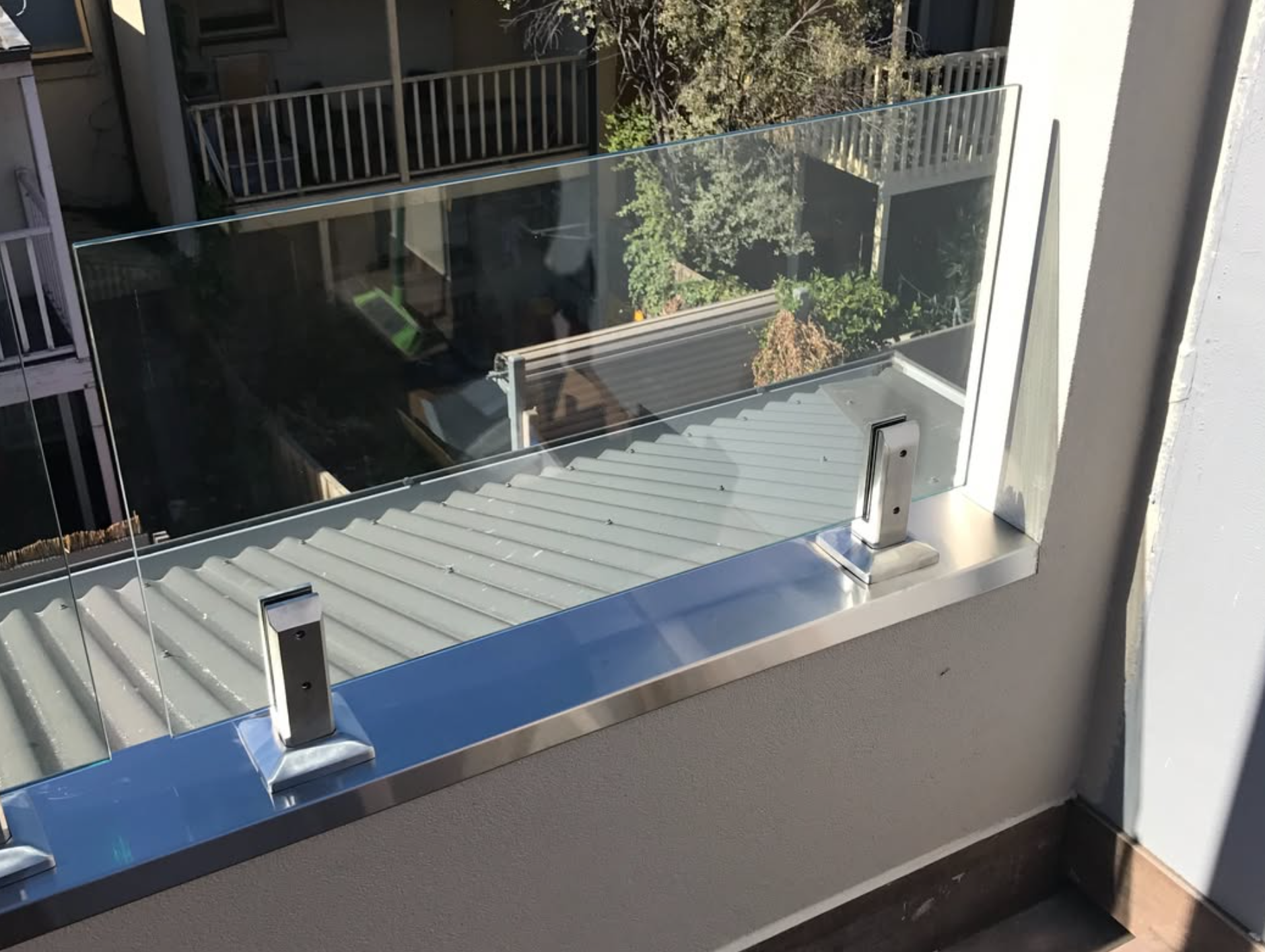 Frameless glass balustrade with stainless spigots on Melbourne balcony