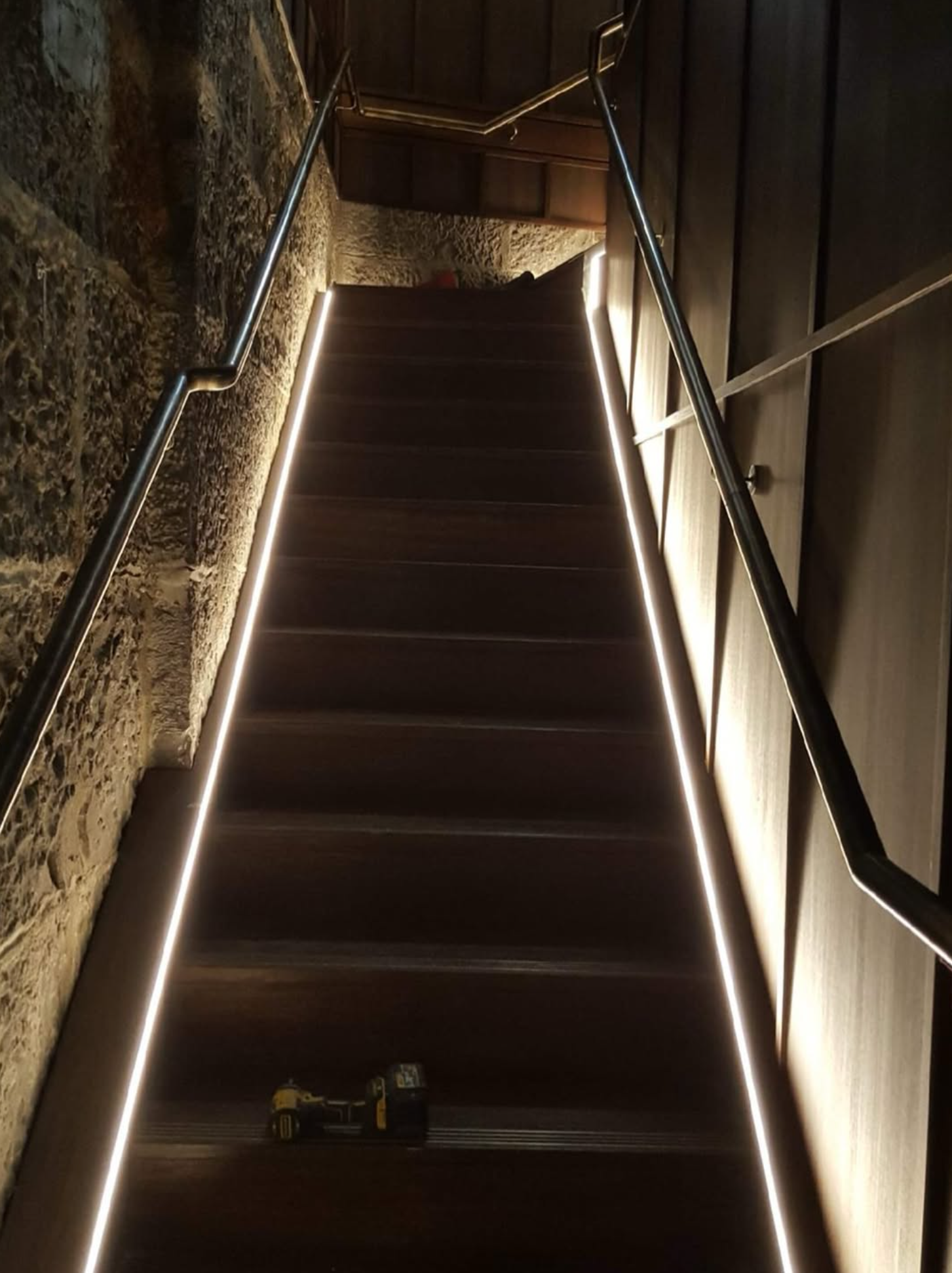 Powder-coated steel handrails with LED lighting on internal staircase